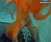 Yellow and Red clothed teen underwater from pool shower and spa nudist