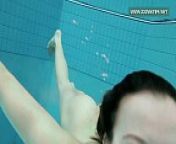 Podvodkova swimming in blue bikini in the pool from like fish in water
